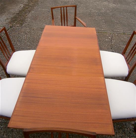 A Gordon Russell teak extending dining table and six chairs (4+2 carvers)